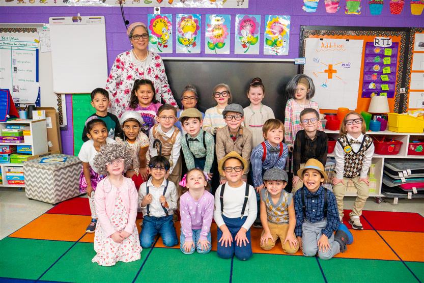 classroom of students and teacher dressed as 100 year olds